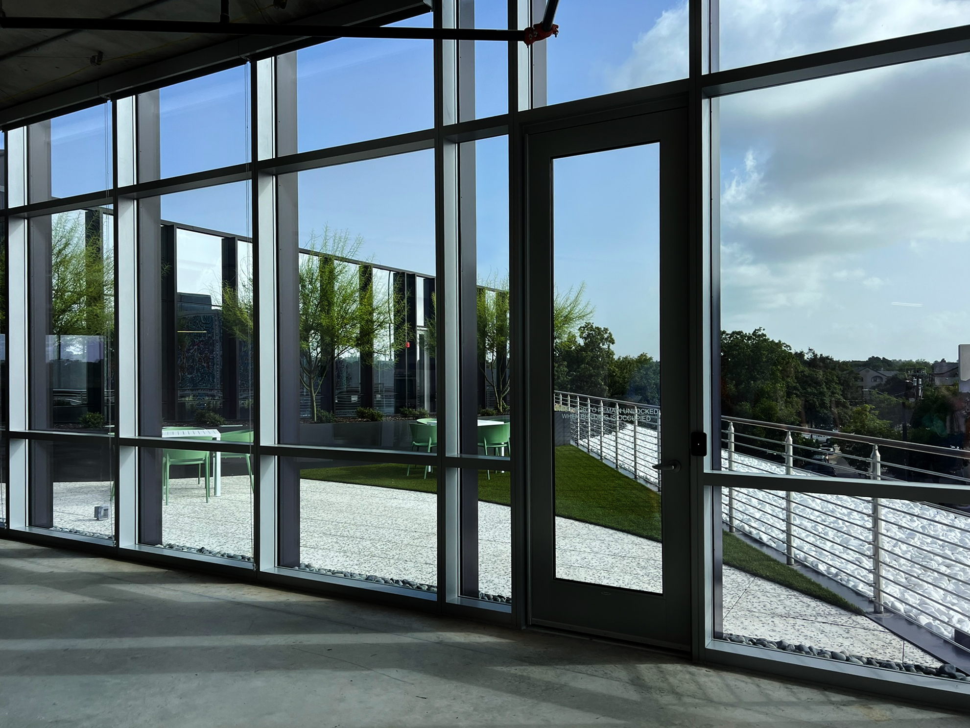 The terrace seen from inside the building through full-height glazing