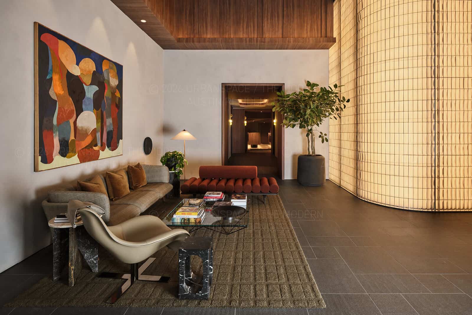 Lobby lounge with a fluted glass wall and a large ficus in a dark vessel
