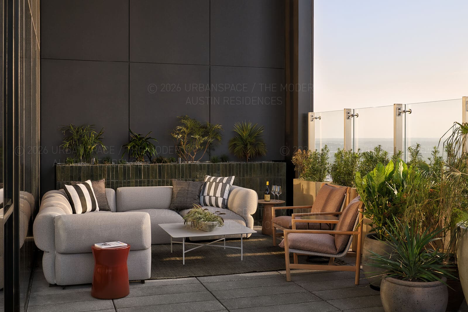 Terrace lounge at dusk, rosemary and sedges in vessels along the glass rail
