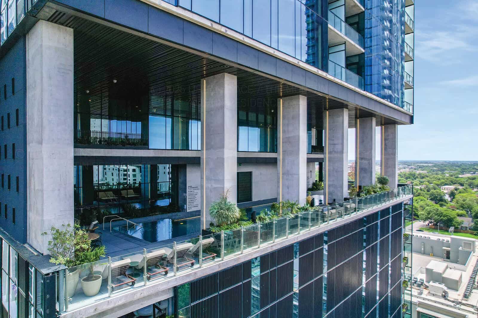 Aerial view of the amenity floor showing the pool and planted parapet edge