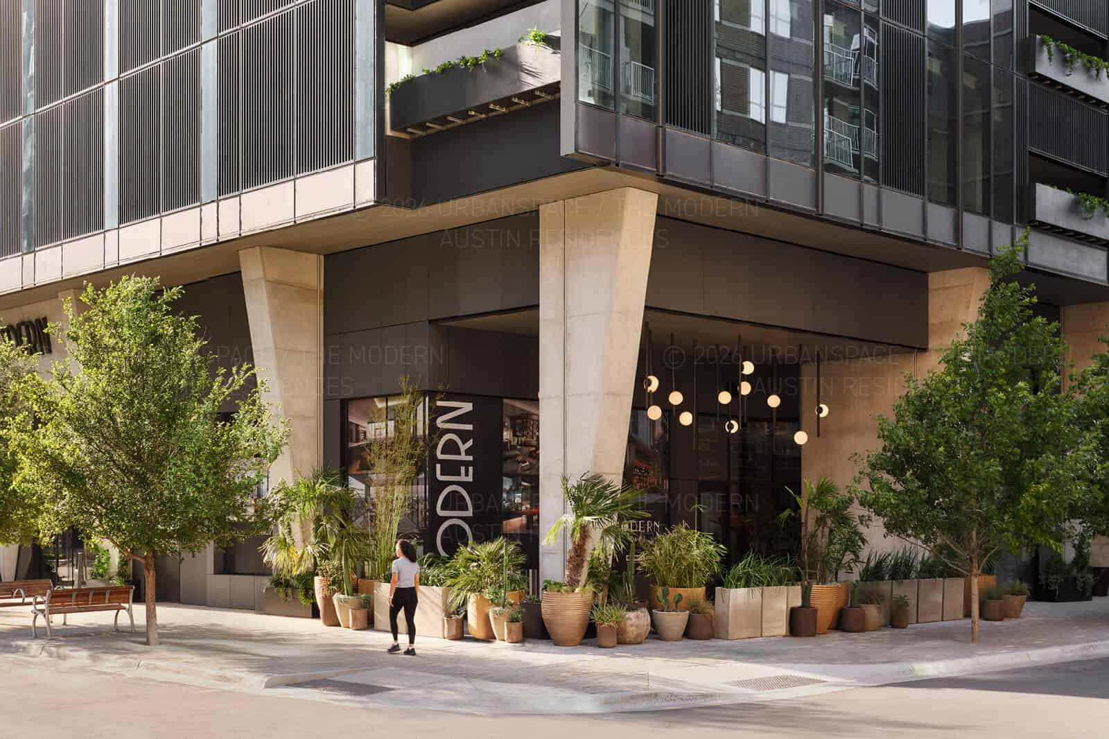 The corner of The Modern with a dense collection of planted vessels along the sidewalk