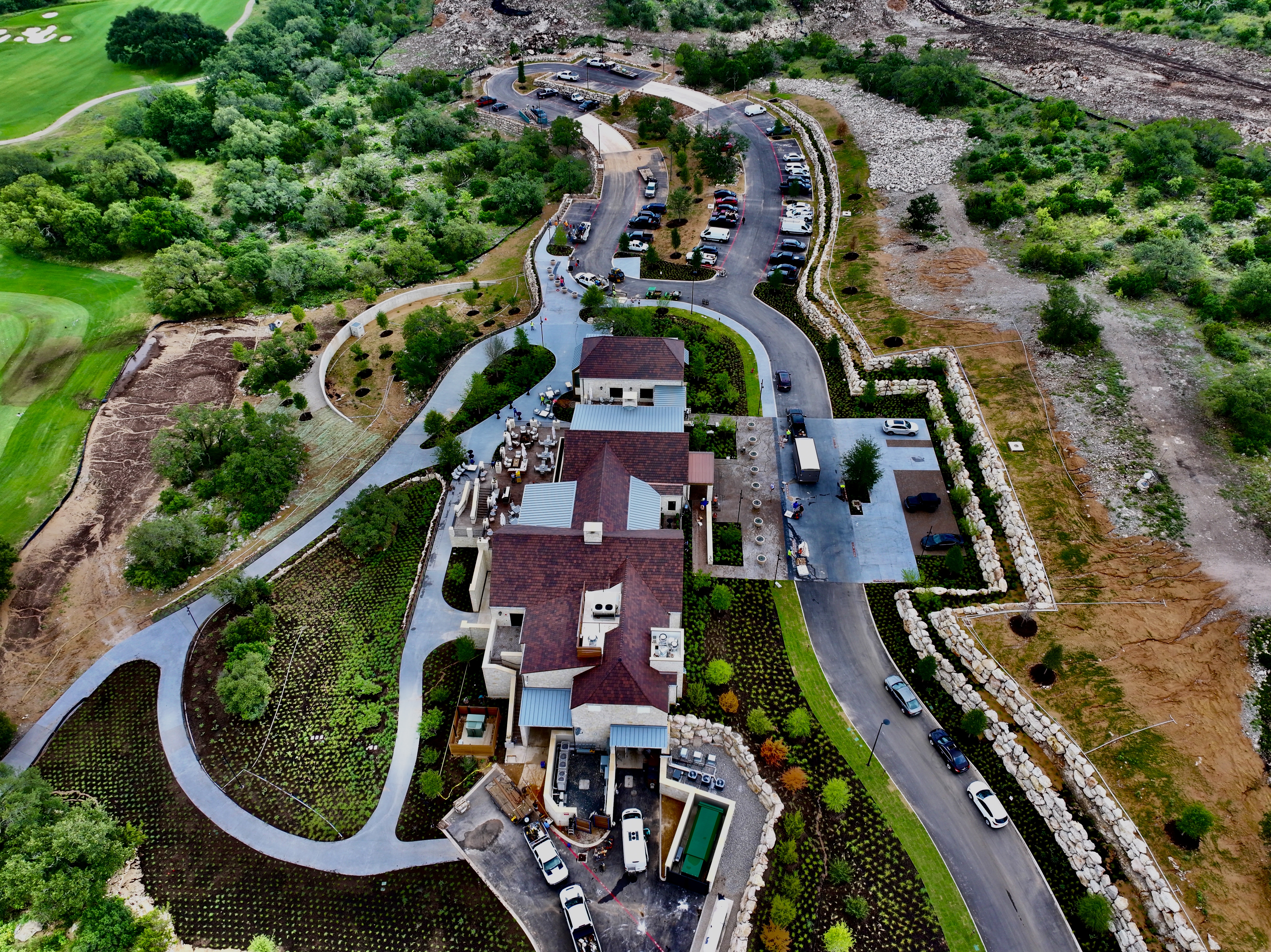 Closer oblique aerial of the clubhouse terraces, mass planting beds and stone walls